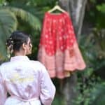 Beautiful bride's vintage-inspired look with jewelry, preparing for wedding.