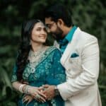 Stunning Indian couple dressed in vibrant traditional wedding attire outdoors.